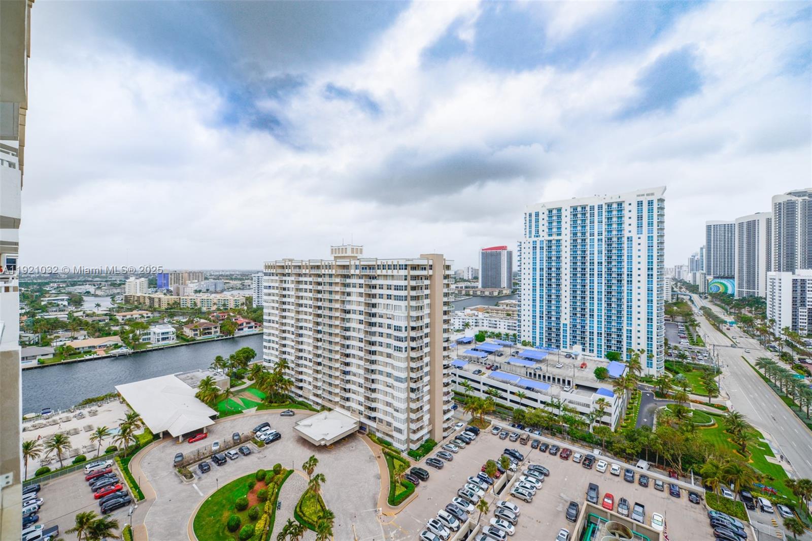 An elevated view shows high-rise apartment buildings, a canal, and a large parking lot — 1985 S Ocean Dr # 17H, Hallandale Beach FL 33009, HALLANDALE BEACH, FL