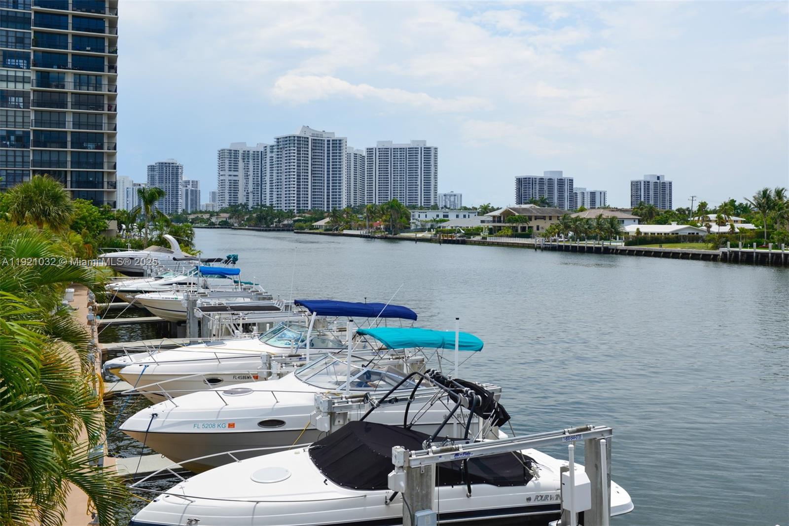 A row of boats is docked along a canal lined with high-rise apartment buildings — 1985 S Ocean Dr # 17H, Hallandale Beach FL 33009, HALLANDALE BEACH, FL