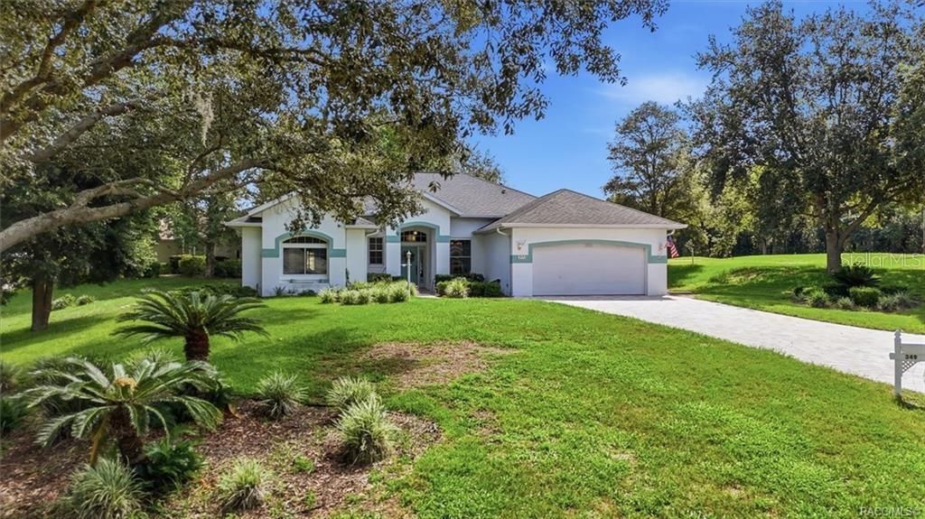 A single-story house with a white exterior, a two-car garage, and a landscaped front yard — 349 W CRESTMONT COURT, BEVERLY HILLS, FL