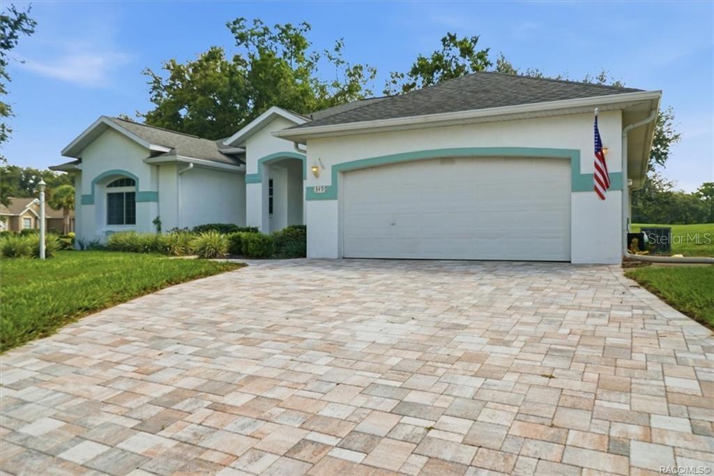A single-story house with a white stucco exterior, teal accents, and a paved driveway — 349 W CRESTMONT COURT, BEVERLY HILLS, FL