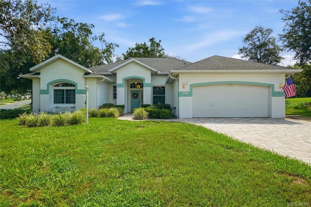 A single-story house with a two-car garage, teal trim, and a paved driveway — 349 W CRESTMONT COURT, BEVERLY HILLS, FL