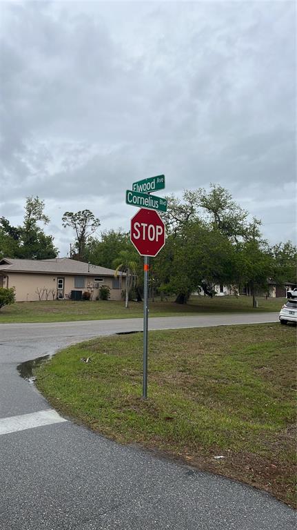 A stop sign stands at the intersection of Elwood Avenue and Cornelius Boulevard — 15010 ELWOOD AVENUE, PORT CHARLOTTE, FL