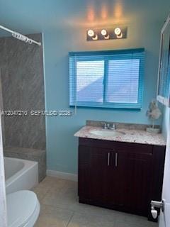 A bathroom features a dark wood vanity, a light countertop, and a window with blinds — 75 Coral Dr, Key Largo FL 33037, KEY LARGO, FL