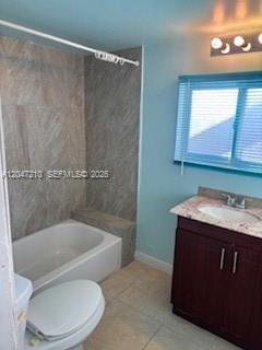 A bathroom features a white tub with gray tile walls, a vanity, and a window — 75 Coral Dr, Key Largo FL 33037, KEY LARGO, FL