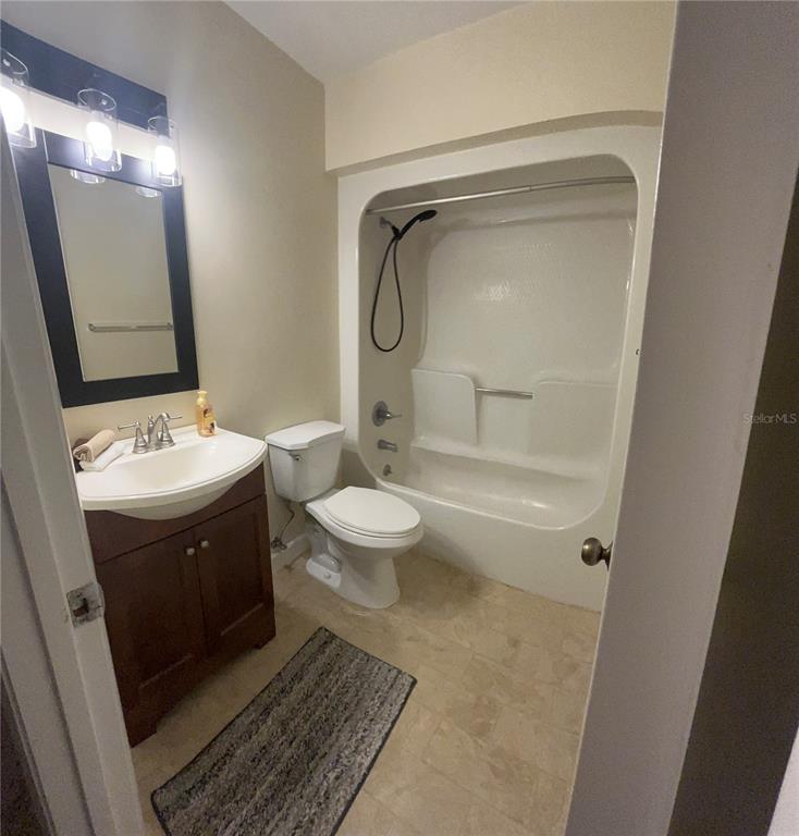 A bathroom features a vanity with a sink, a toilet, and a shower-tub combination — 308 PALM COAST PARKWAY NE UNIT 203, PALM COAST, FL
