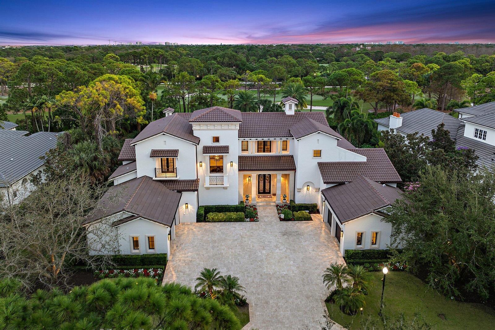 An aerial view of a large white two-story house with a brown tile roof — 135 W Bears Club Drive, Jupiter FL 33477, JUPITER, FL