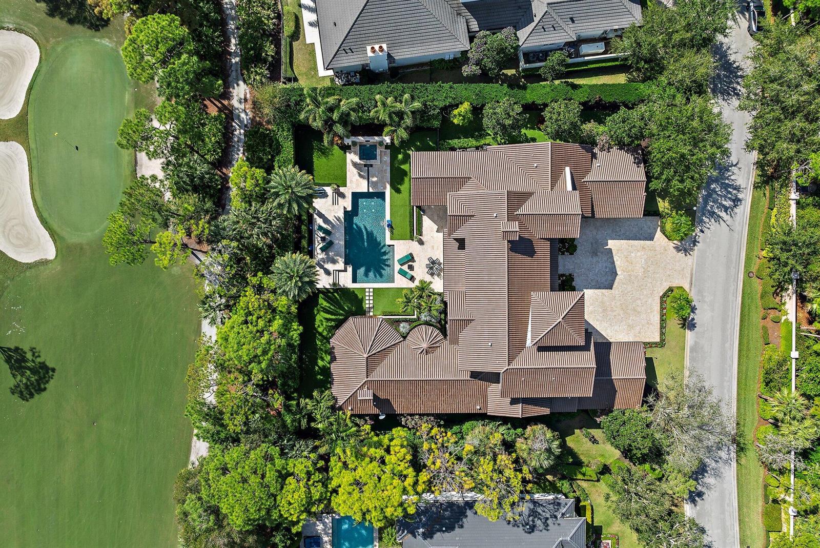 An aerial view shows a large house with a tiled roof, pool, and golf course — 135 W Bears Club Drive, Jupiter FL 33477, JUPITER, FL