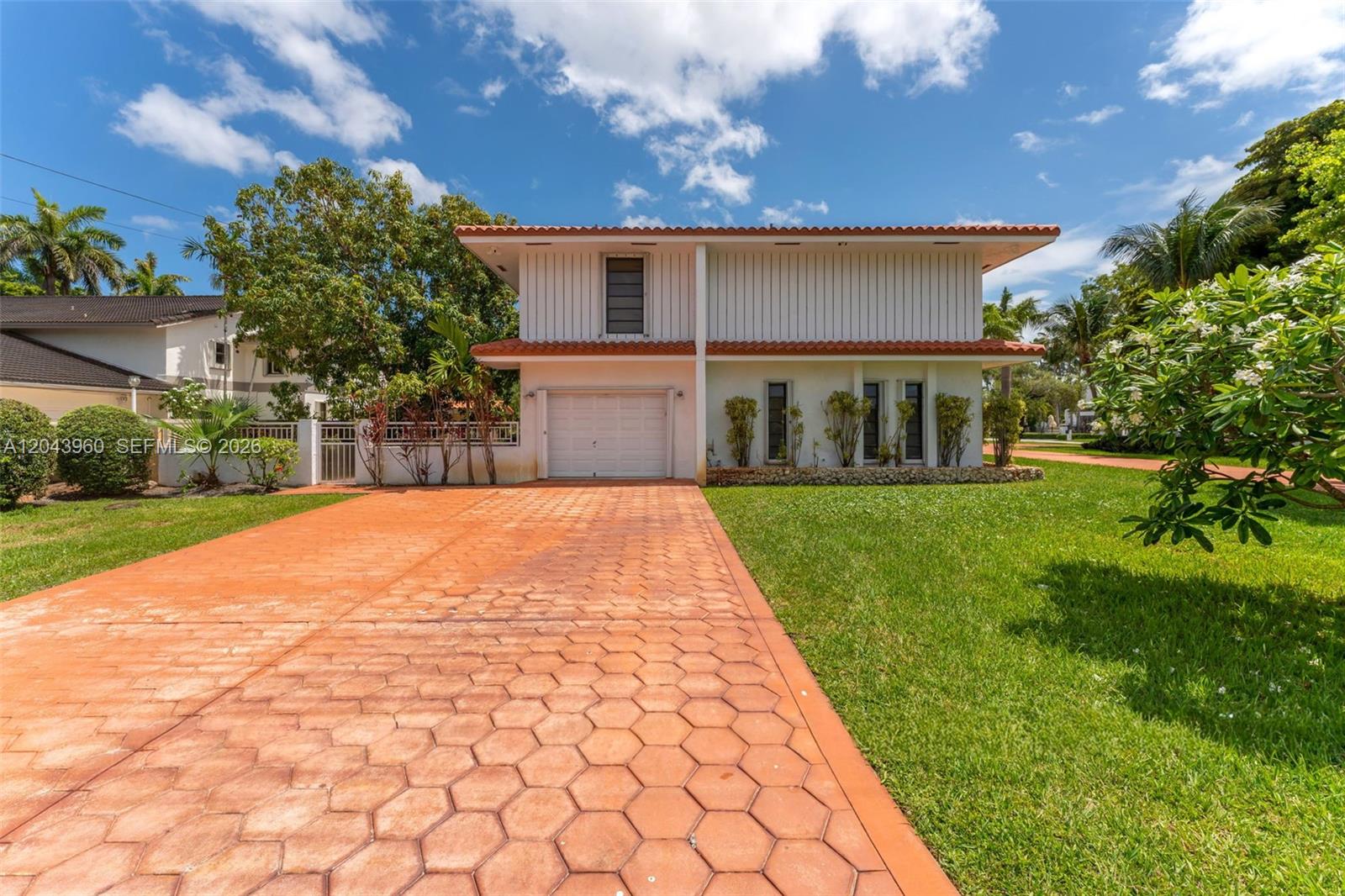 A two-story house with a white facade, a tiled roof, and a patterned driveway — 8390 SW 2nd St # 0, Miami FL 33144, MIAMI, FL