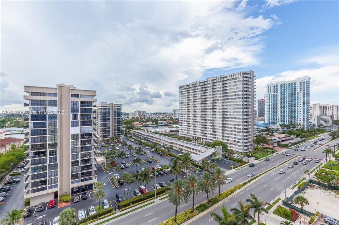An elevated view shows multiple high-rise apartment buildings, a parking lot, and a nearby road — 2030 S Ocean Dr # 1706, Hallandale Beach FL 33009, HALLANDALE BEACH, FL