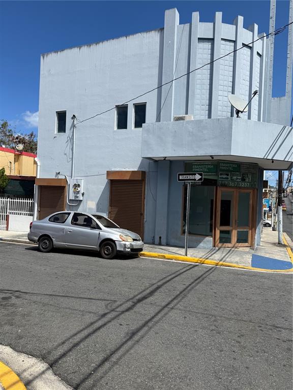 A light blue two-story commercial building with a silver car parked in front — 2121 EDUARDO CONDE, SAN JUAN, PR