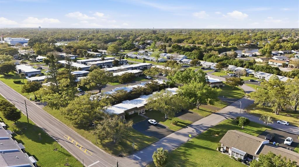 An aerial view shows a residential neighborhood with single-story buildings, paved streets, and mature trees — 3504 38TH STREET W, BRADENTON, FL
