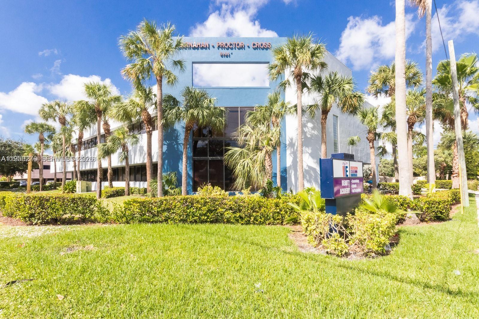 A two-story commercial building with a blue facade and palm trees in front — 6101 W Atlantic Blvd # 213, Margate FL 33063, MARGATE, FL