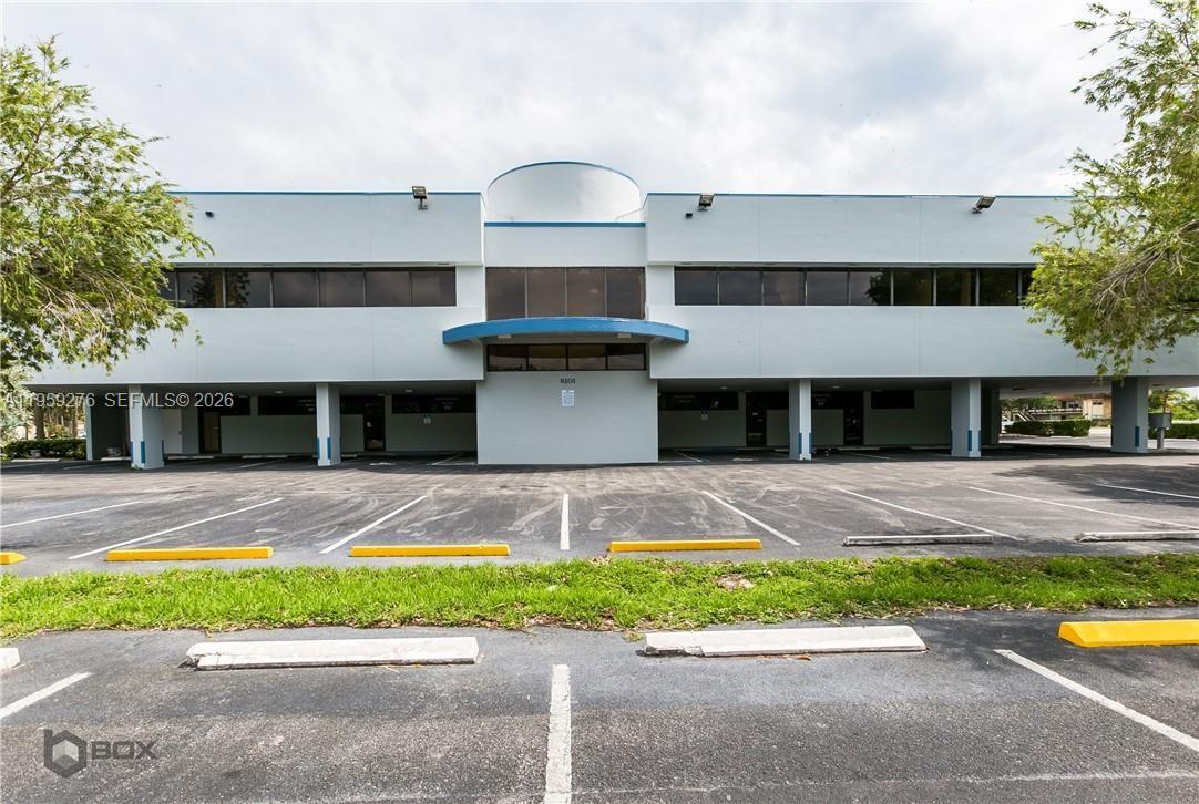 A two-story commercial office building features a covered parking area on the ground level — 6101 W Atlantic Blvd # 213, Margate FL 33063, MARGATE, FL
