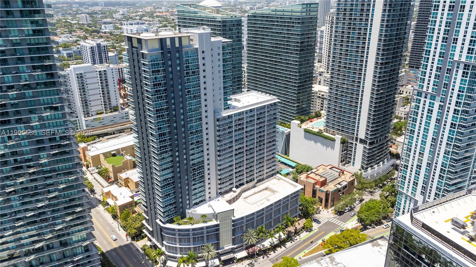 An aerial view of a tall residential skyscraper surrounded by other high-rise buildings in Miami — 1250 S Miami Ave # 3506, Miami FL 33130, MIAMI, FL