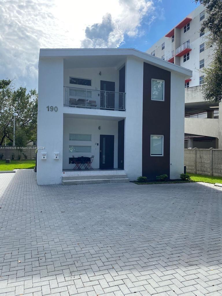 A two-story modern building with white and dark brown exterior walls and a paved driveway — 190 NW 57th St, Miami FL 33127, MIAMI, FL