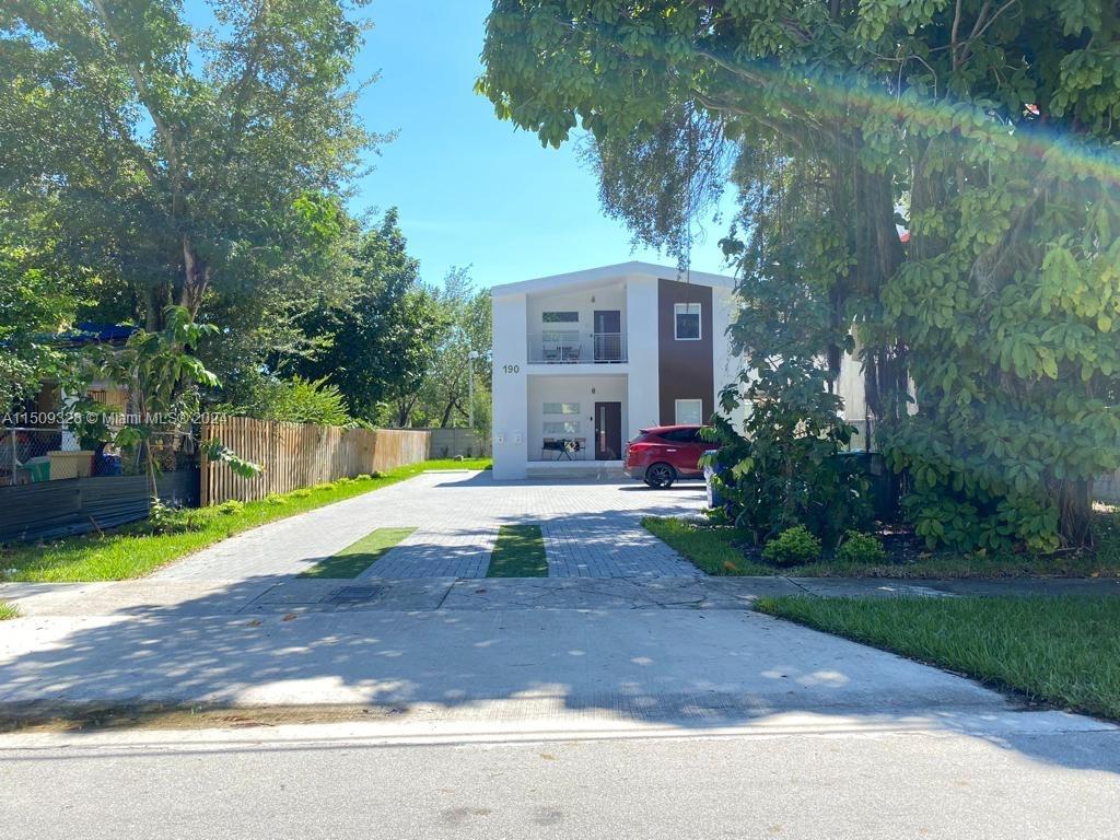 A two-story modern house with a paved driveway and a red car parked in front — 190 NW 57th St, Miami FL 33127, MIAMI, FL
