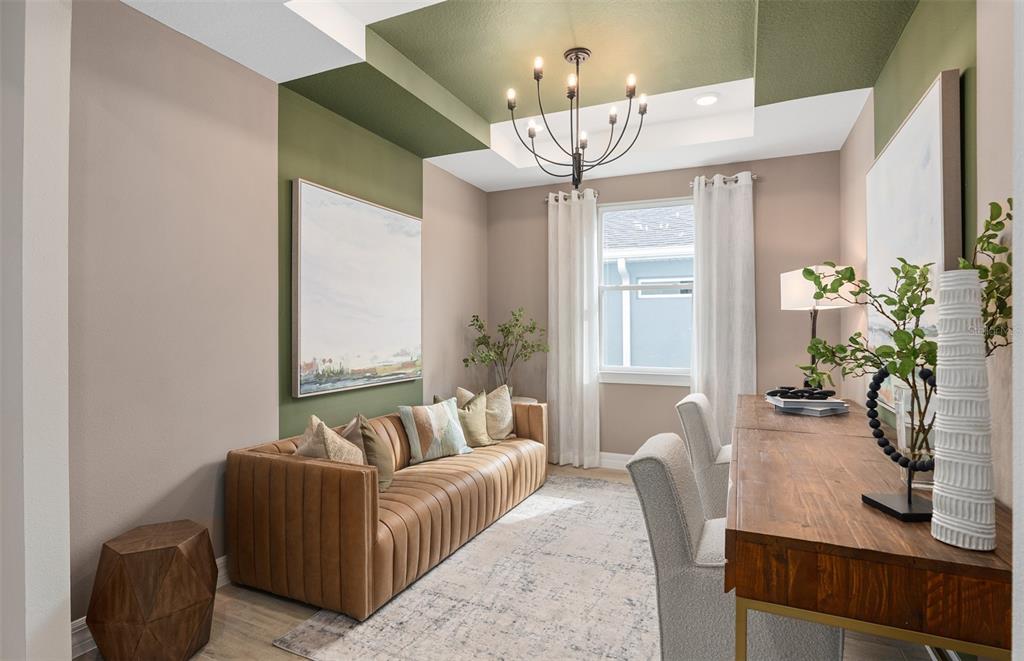 A home office features a brown leather sofa, a wooden desk, and green ceiling accents — 2810 LOFTBRIDGE ROAD, MINNEOLA, FL