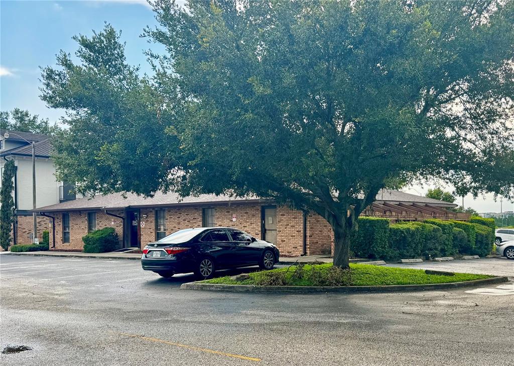 A brick office building with a large tree in the parking lot — 1619 E VINE STREET, KISSIMMEE, FL