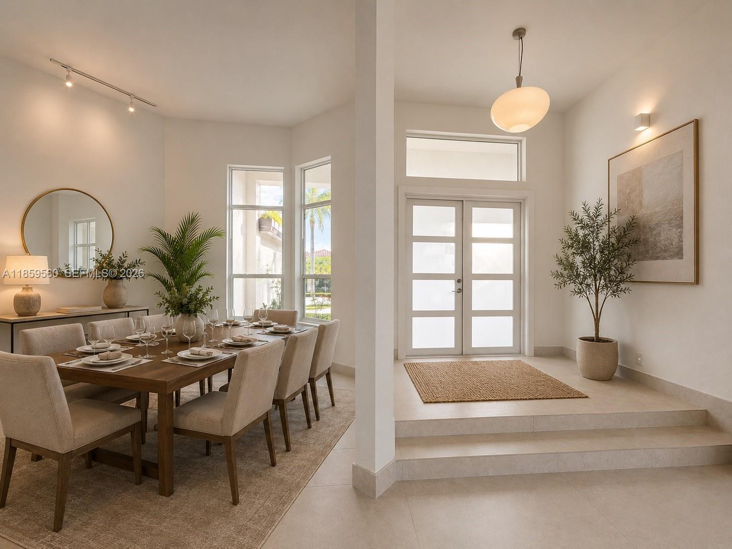 A dining area with a wooden table sits next to a raised entryway with double doors — 2523 Montclaire Cir, Weston FL 33327, WESTON, FL