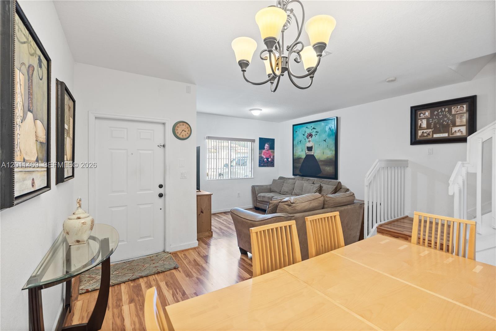 This living and dining area features wood flooring, a chandelier, and a brown sectional sofa — 8430 SW 150th Ave # 2, Miami FL 33193, MIAMI, FL