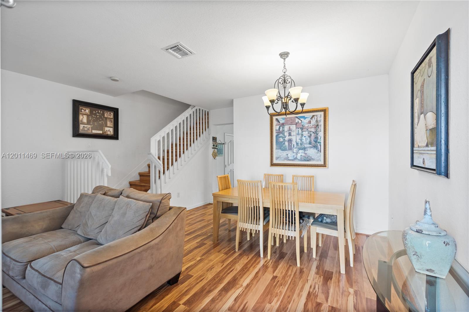 A living room with a staircase, dining area, and light wood flooring — 8430 SW 150th Ave # 2, Miami FL 33193, MIAMI, FL