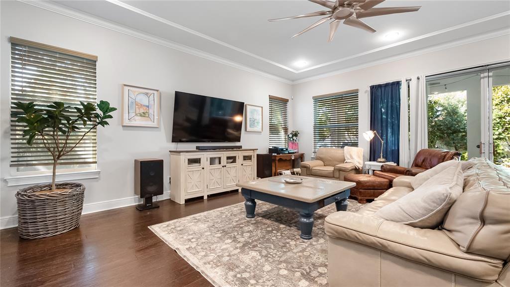 A living room features a large television, a coffee table, and leather seating — 1500 RACKETS COURT, LAKE MARY, FL