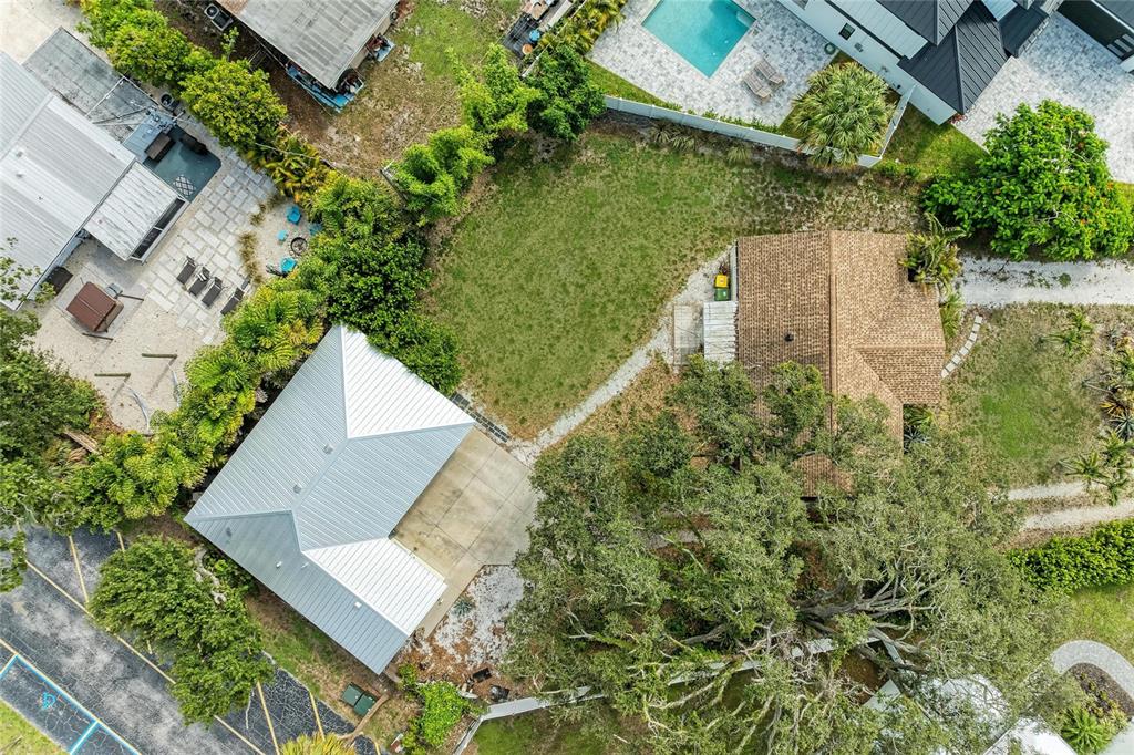 An aerial view shows two houses with a grassy yard and mature trees between them — 1300 LOMA LINDA COURT, SARASOTA, FL