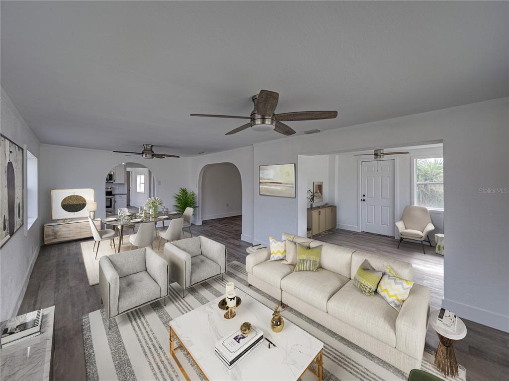 An open-concept living and dining area features light gray flooring, white walls, and ceiling fans — 602 E LAURA STREET, PLANT CITY, FL