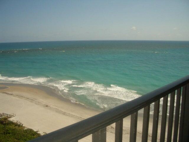 A view of the ocean and sandy beach from a balcony with a dark railing — 300 Ocean Trail Way # 1302, Jupiter FL 33477, JUPITER, FL