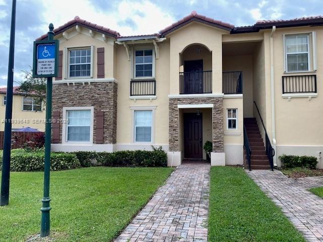 A two-story residential building features tan stucco walls, stone veneer accents, and a brick walkway — 3360 NE 14th Dr # 30, Homestead FL 33033, HOMESTEAD, FL