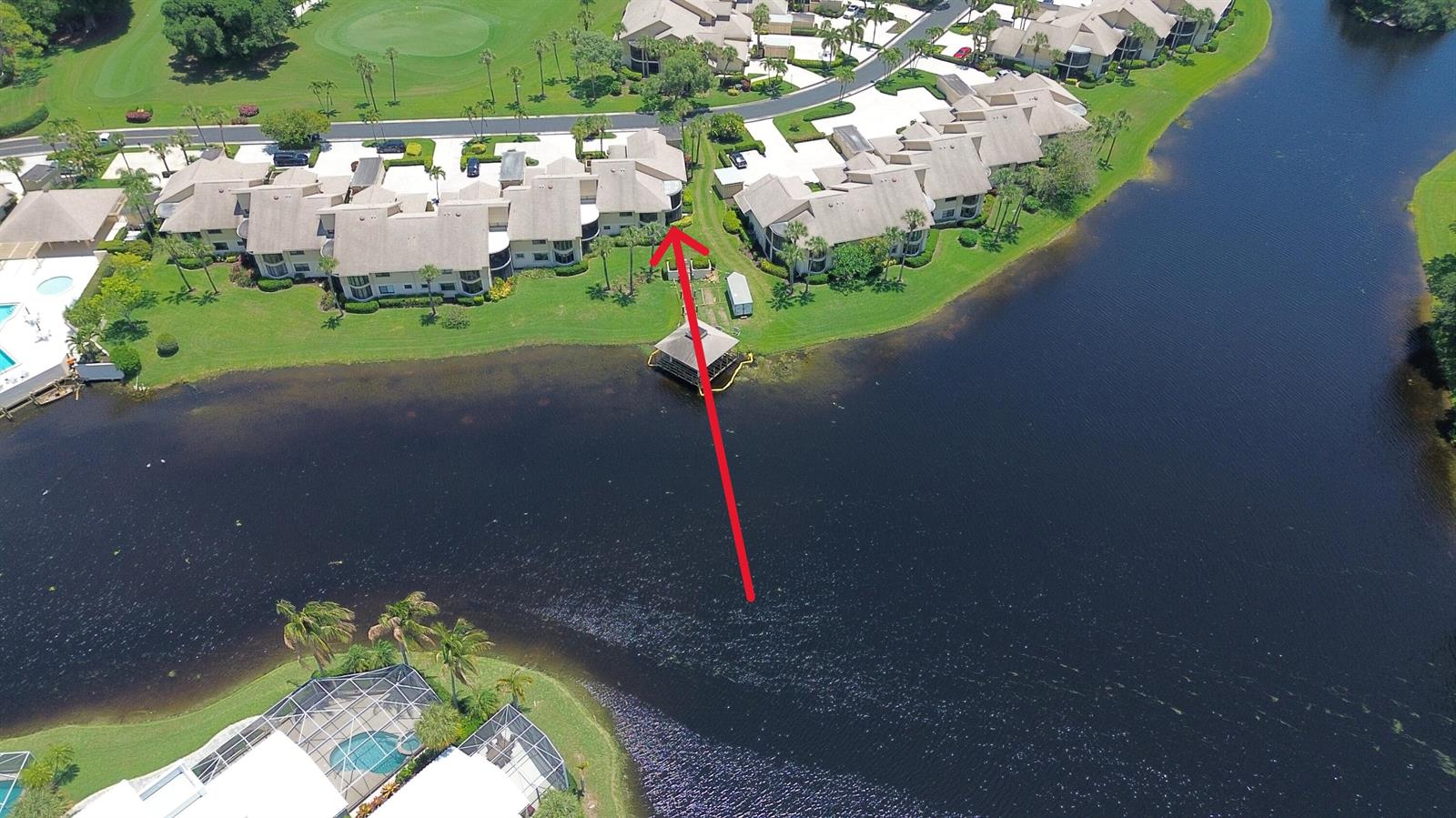 An aerial view shows a residential complex with a red arrow pointing toward a gazebo — 16997 Waterbend Drive # 139, Jupiter FL 33477, JUPITER, FL
