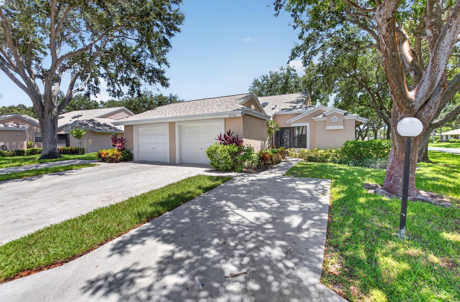 A tan single-story house with a two-car garage and a concrete driveway — 8306 Summersong Terrace, Boca Raton FL 33496, BOCA RATON, FL