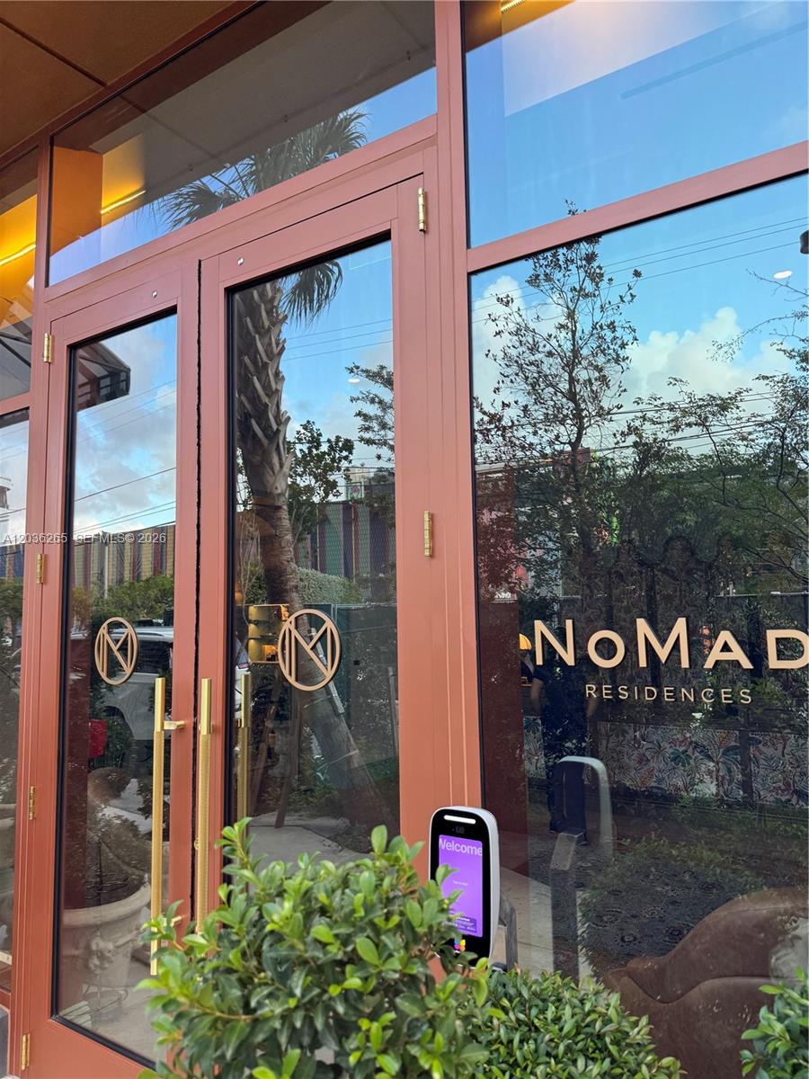 A glass-paned entrance door features the NoMad Residences logo and a digital access panel — 2700 NW 2nd Ave # 240, Miami FL 33127, MIAMI, FL