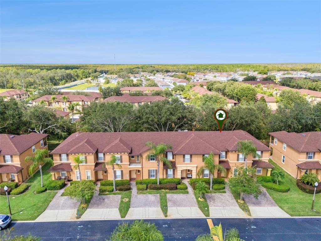 An aerial view of a multi-unit residential building with a brown shingled roof — 245 CAMBRIA AVENUE, DAVENPORT, FL