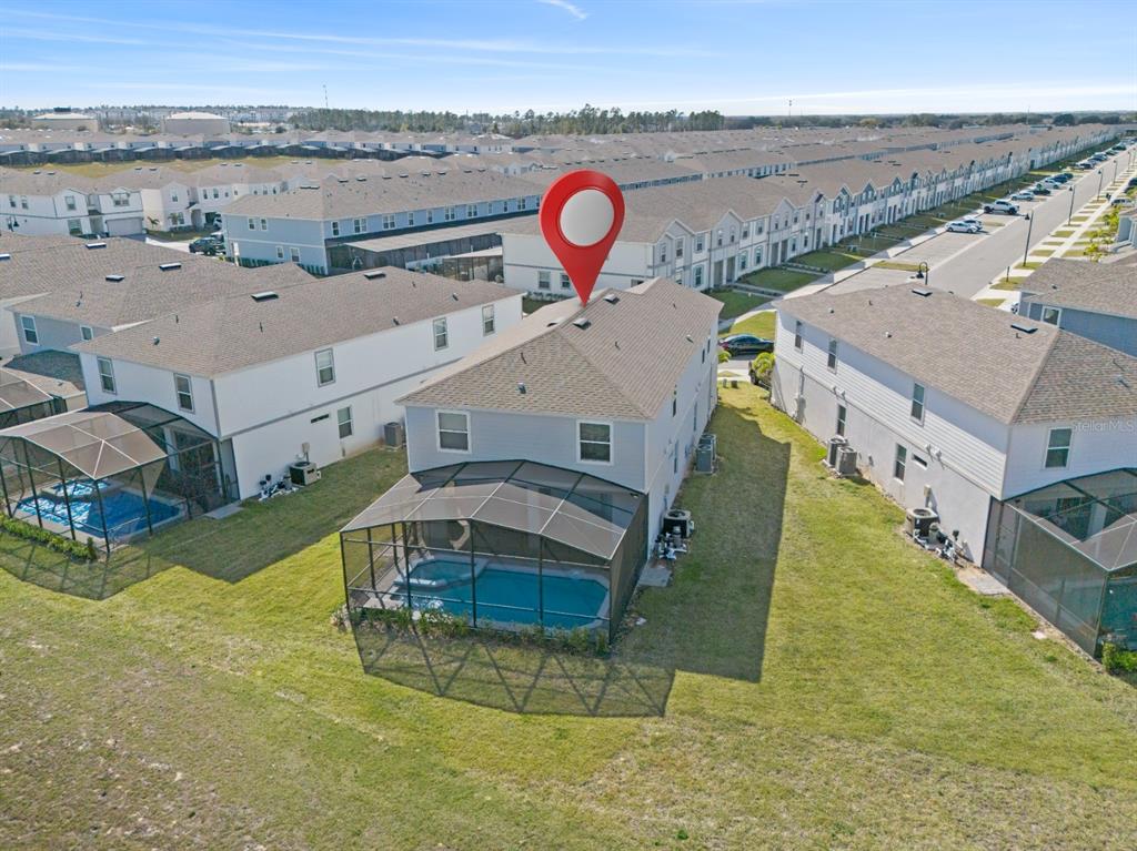 An aerial view shows a two-story house with a screened-in pool and backyard — 3787 LANA AVENUE, DAVENPORT, FL