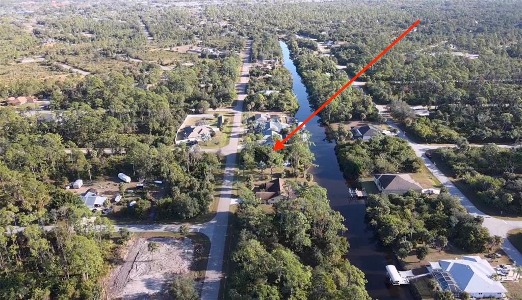 An aerial view shows a residential property with a house situated along a canal — 468 CORY STREET, PORT CHARLOTTE, FL