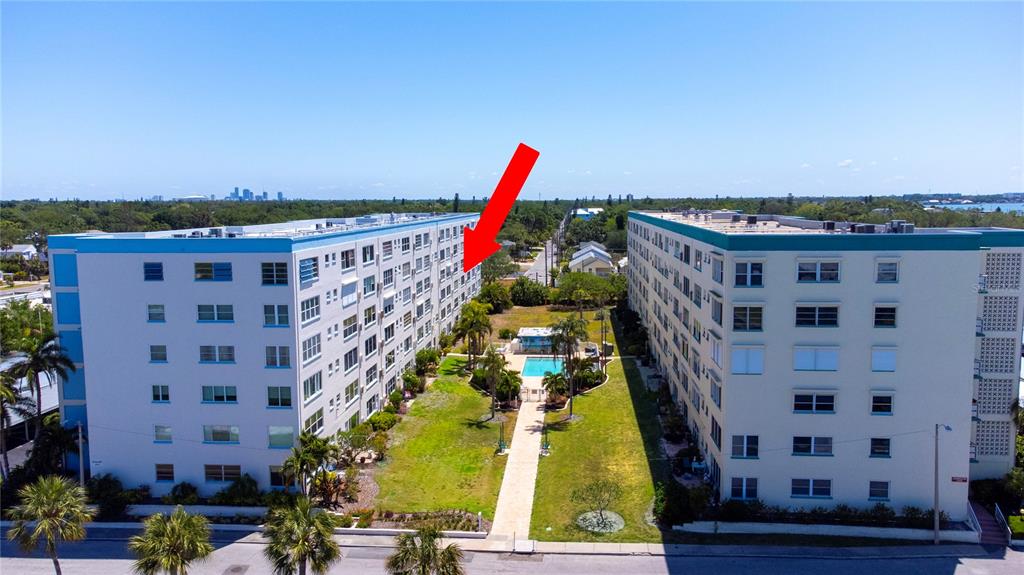 An aerial view shows two multi-story apartment buildings separated by a courtyard with a pool — 2850 59TH STREET S UNIT 205, GULFPORT, FL