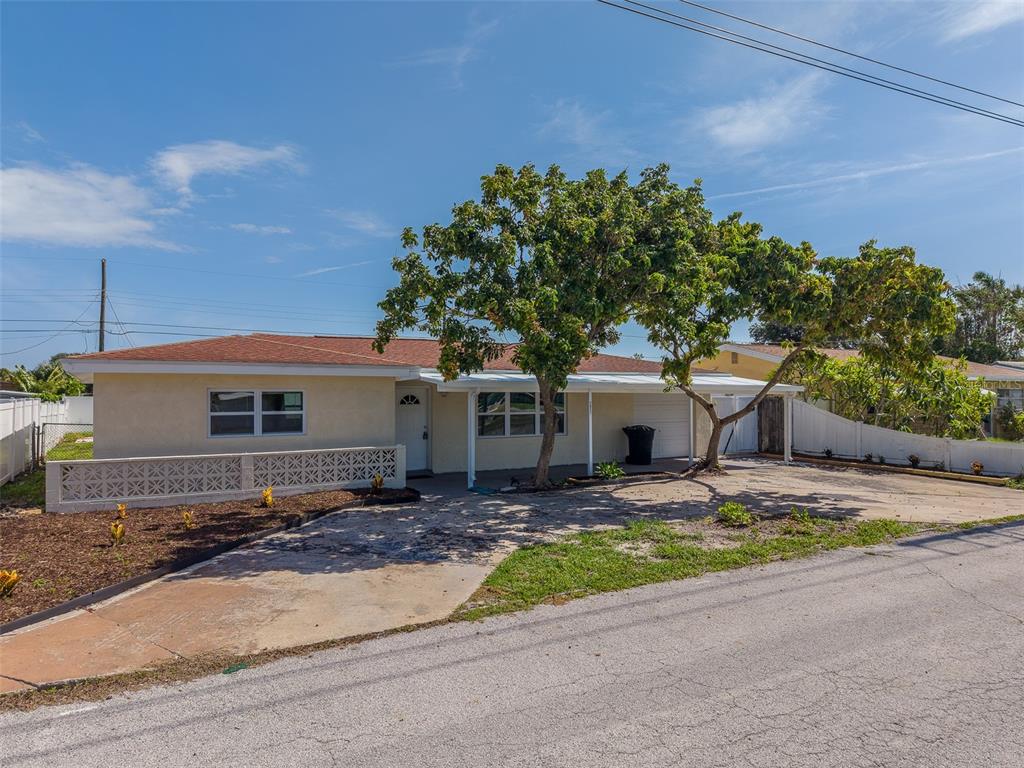 A single-story house with a carport, a decorative concrete block wall, and a large tree — 5937 38TH AVENUE N, ST PETERSBURG, FL