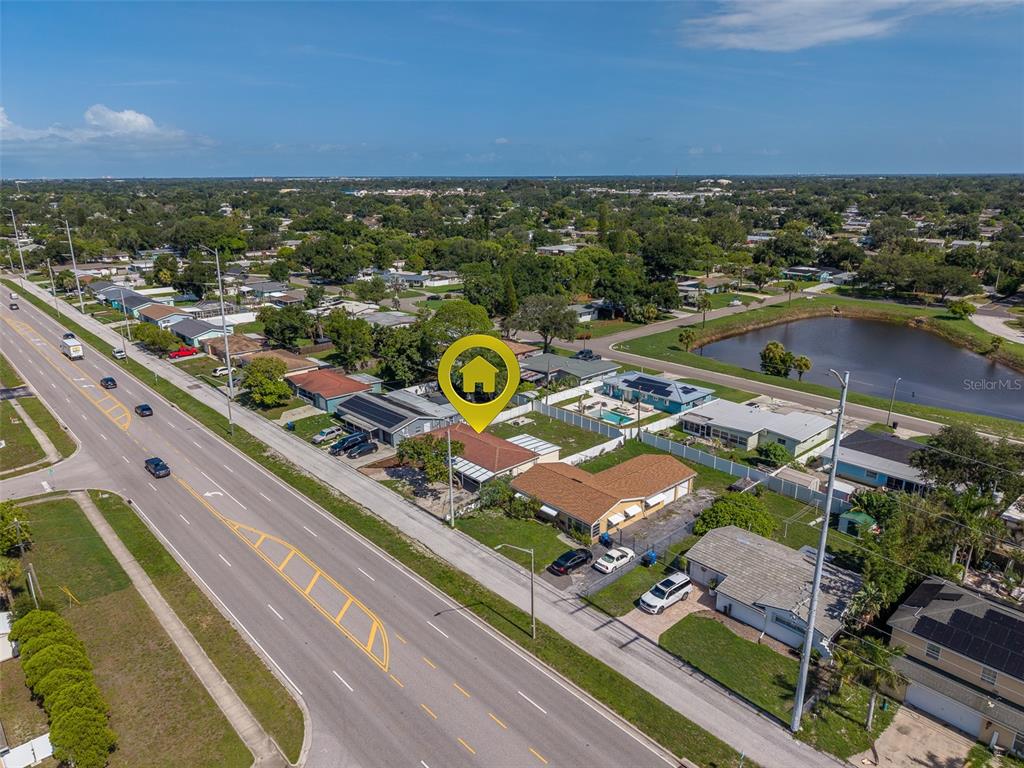 An aerial view shows a residential neighborhood with a house marked by a yellow icon — 5937 38TH AVENUE N, ST PETERSBURG, FL
