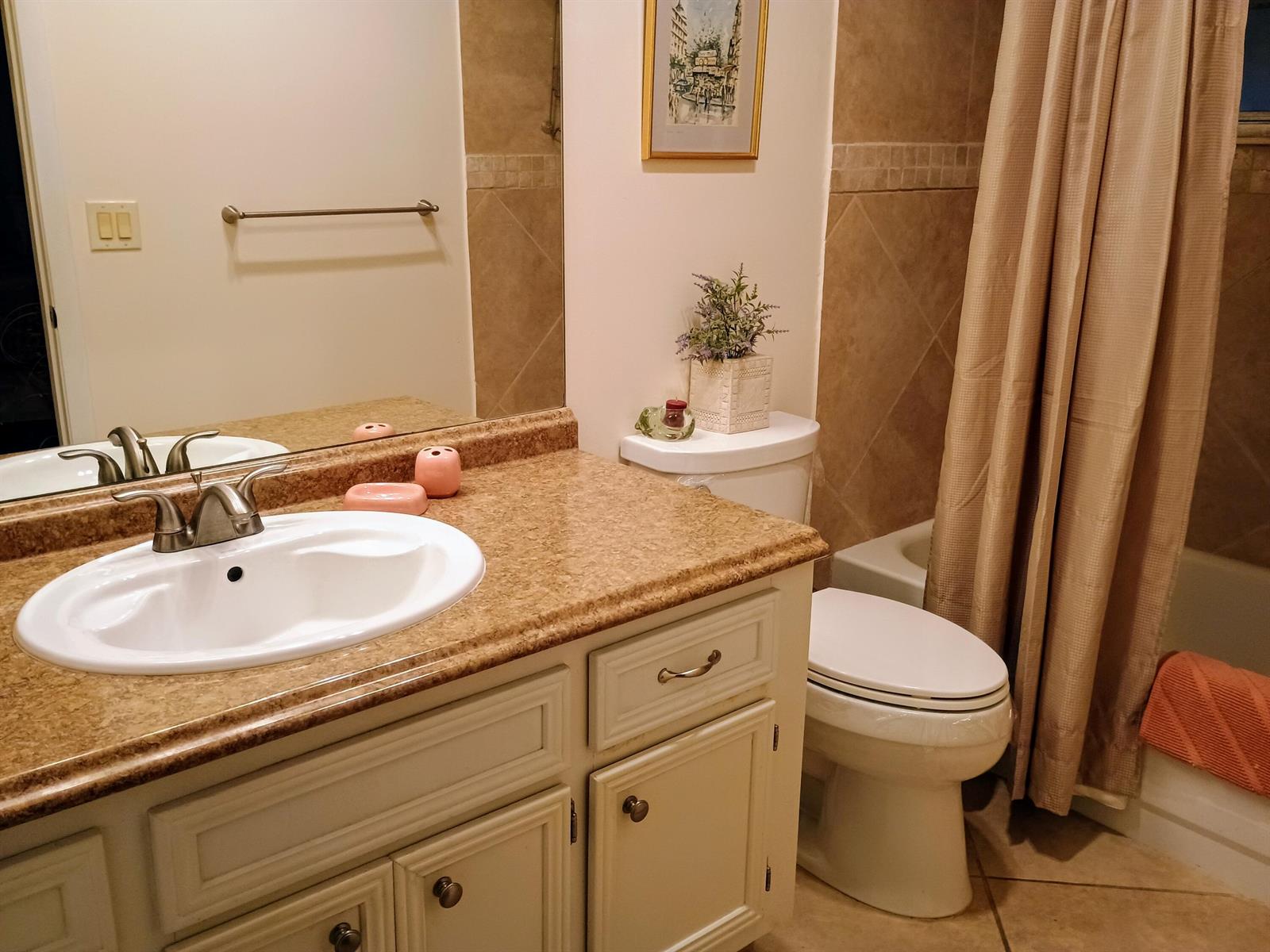 A bathroom features a beige vanity with a white sink, a toilet, and a shower curtain — 14716 Canalview Drive # D, Delray Beach FL 33484, DELRAY BEACH, FL