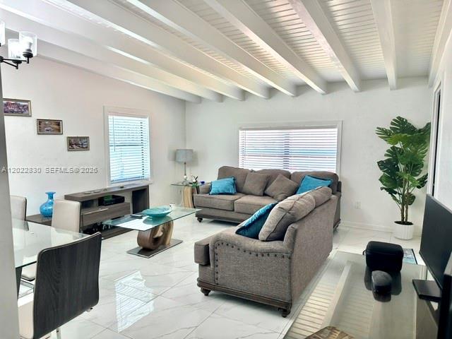 A living room features a gray sofa, a glass coffee table, and a beamed ceiling — 4500 SW 97th Ave, Miami FL 33165, MIAMI, FL