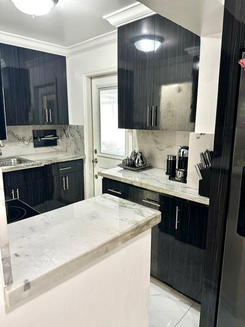 A modern kitchen features dark wood cabinets, white marble countertops, and a white tile floor — 4500 SW 97th Ave, Miami FL 33165, MIAMI, FL