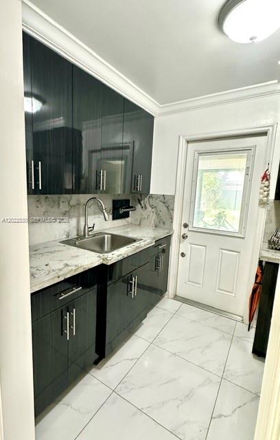 A kitchen features dark glossy cabinets, a marble-patterned countertop, and a white door — 4500 SW 97th Ave, Miami FL 33165, MIAMI, FL
