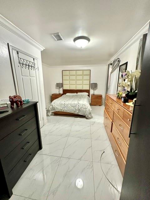 A bedroom features a bed with a tufted headboard, marble-style tile flooring, and two dressers — 4500 SW 97th Ave, Miami FL 33165, MIAMI, FL