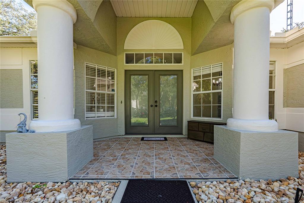 A single-story house with a two-car garage and a concrete driveway sits on a lot — 14214 CINNAMAN LANE, WEEKI WACHEE, FL