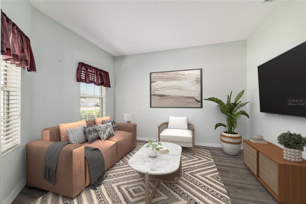 This virtually staged living room features a sofa, accent chair, coffee table, and television — 5330 PECAN RD, OCALA, FL