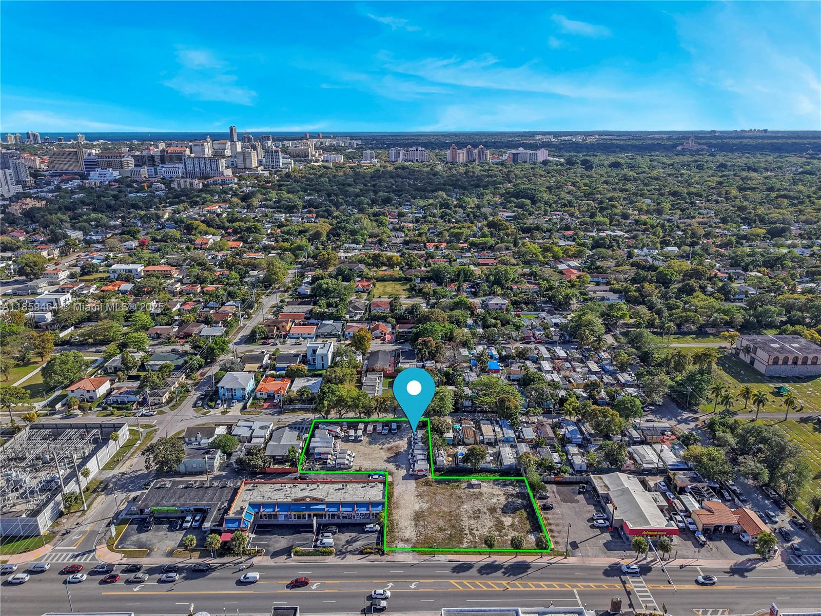 An aerial view shows a commercial property with a parking lot and vacant land — 4350 SW 8th St, Coral Gables FL 33134, CORAL GABLES, FL