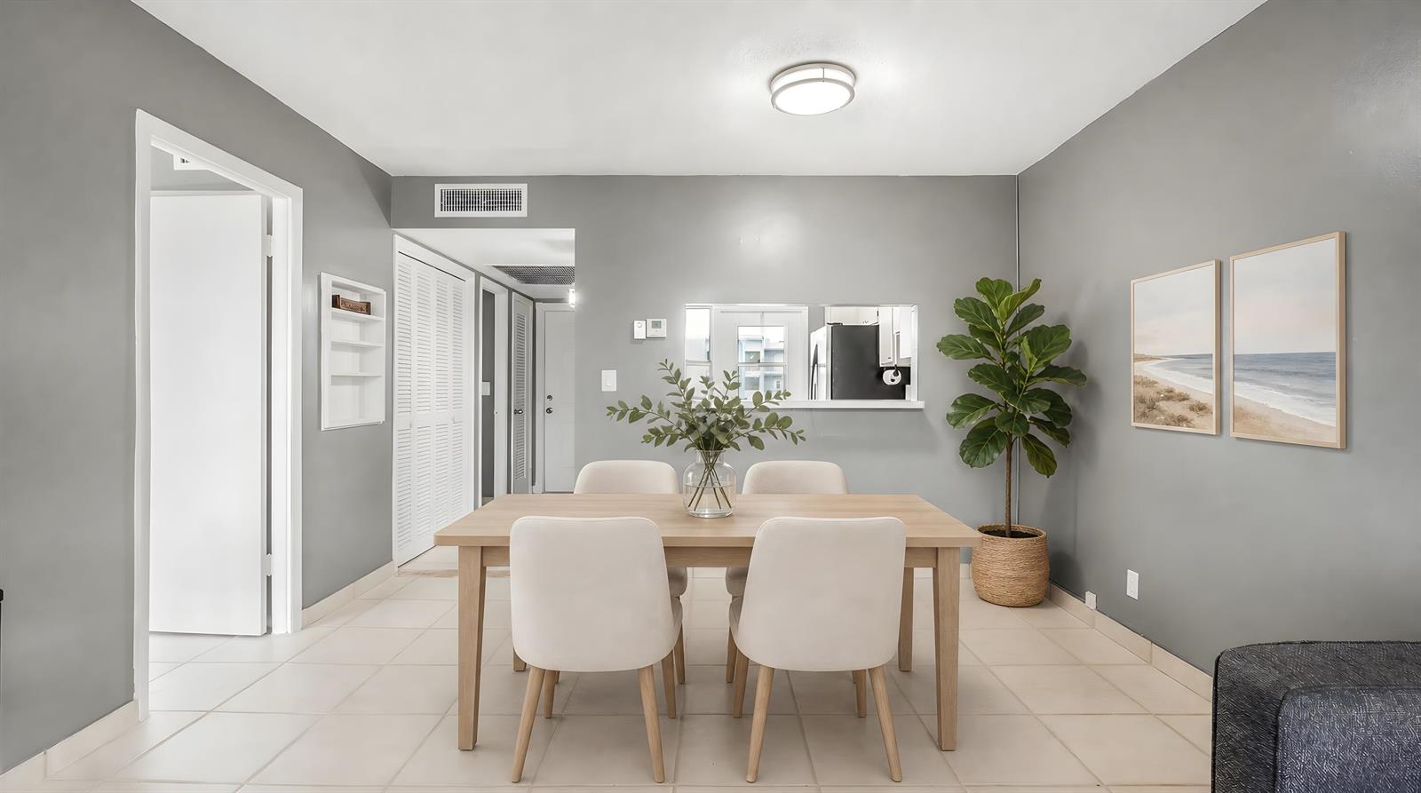 A dining area features a light wood table, four cream chairs, and a potted plant — 2309 Park Lane # 202, Hollywood FL 33021, HOLLYWOOD, FL