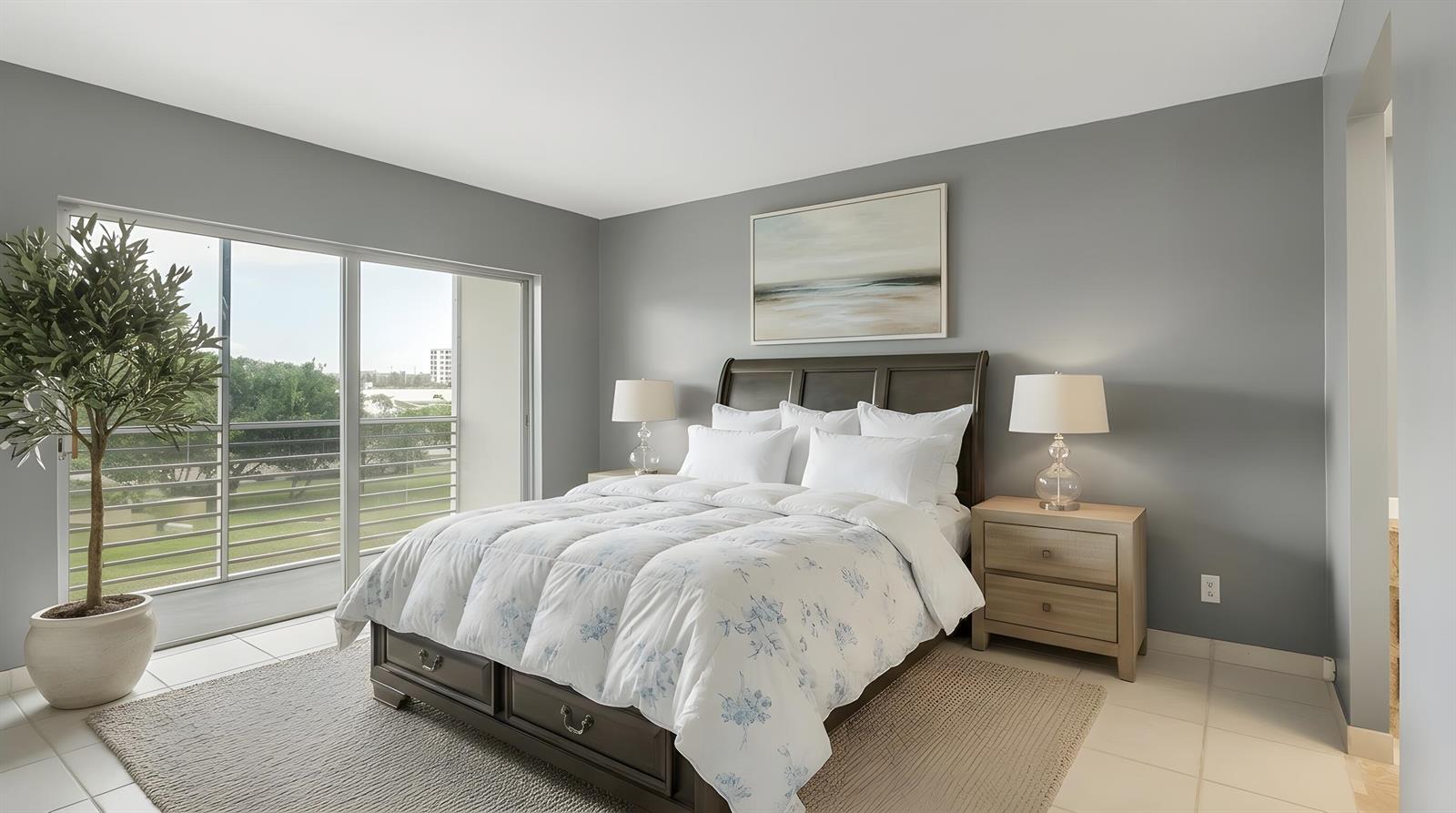 A bedroom features a dark wood bed, gray walls, a large window, and a potted plant — 2309 Park Lane # 202, Hollywood FL 33021, HOLLYWOOD, FL