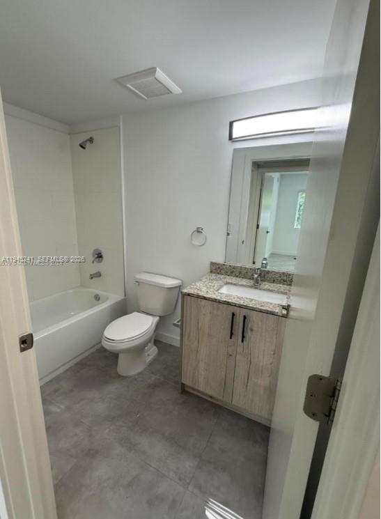 A bathroom features a bathtub, a white toilet, and a vanity with a granite countertop — 14752 NE 6th Ave # 305, Miami FL 33161, MIAMI, FL